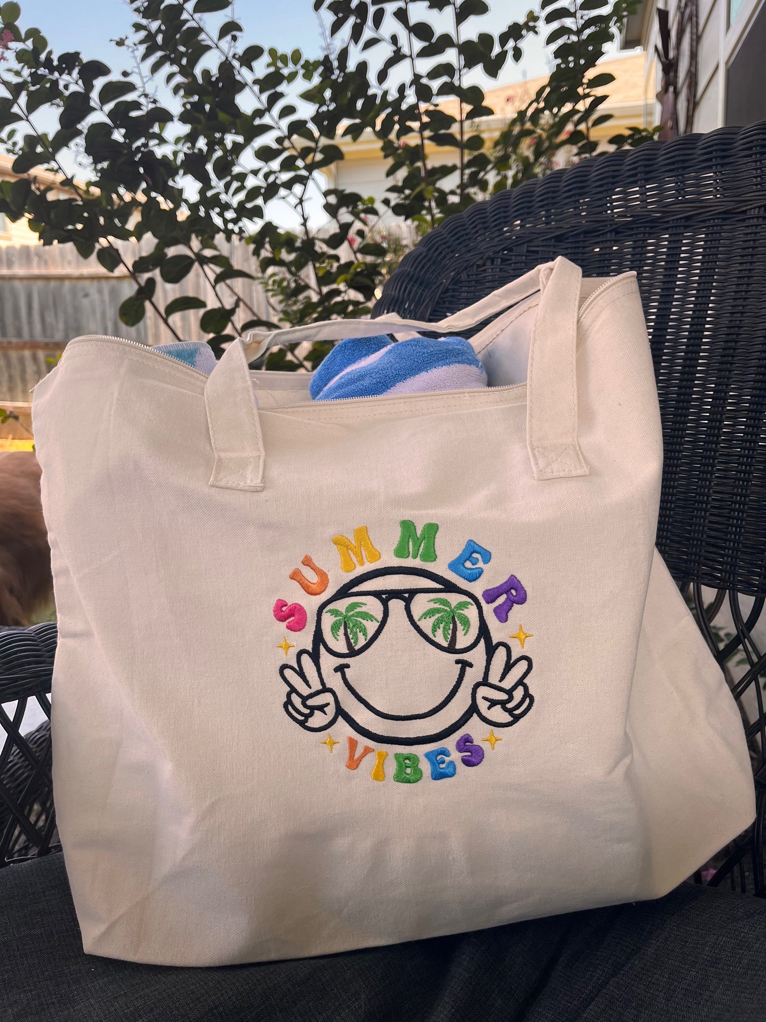 Beige tote bag with colorful text and graphics on a chair outdoors