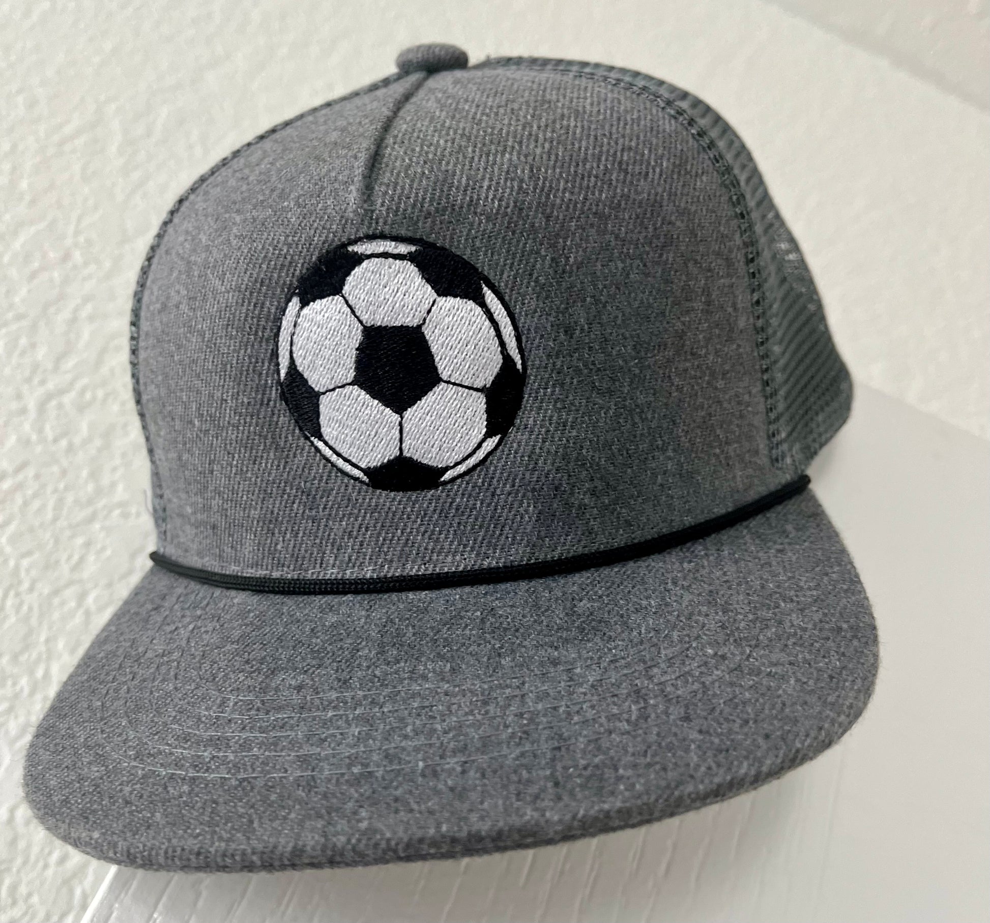 Gray cap with a soccer ball design on a white background