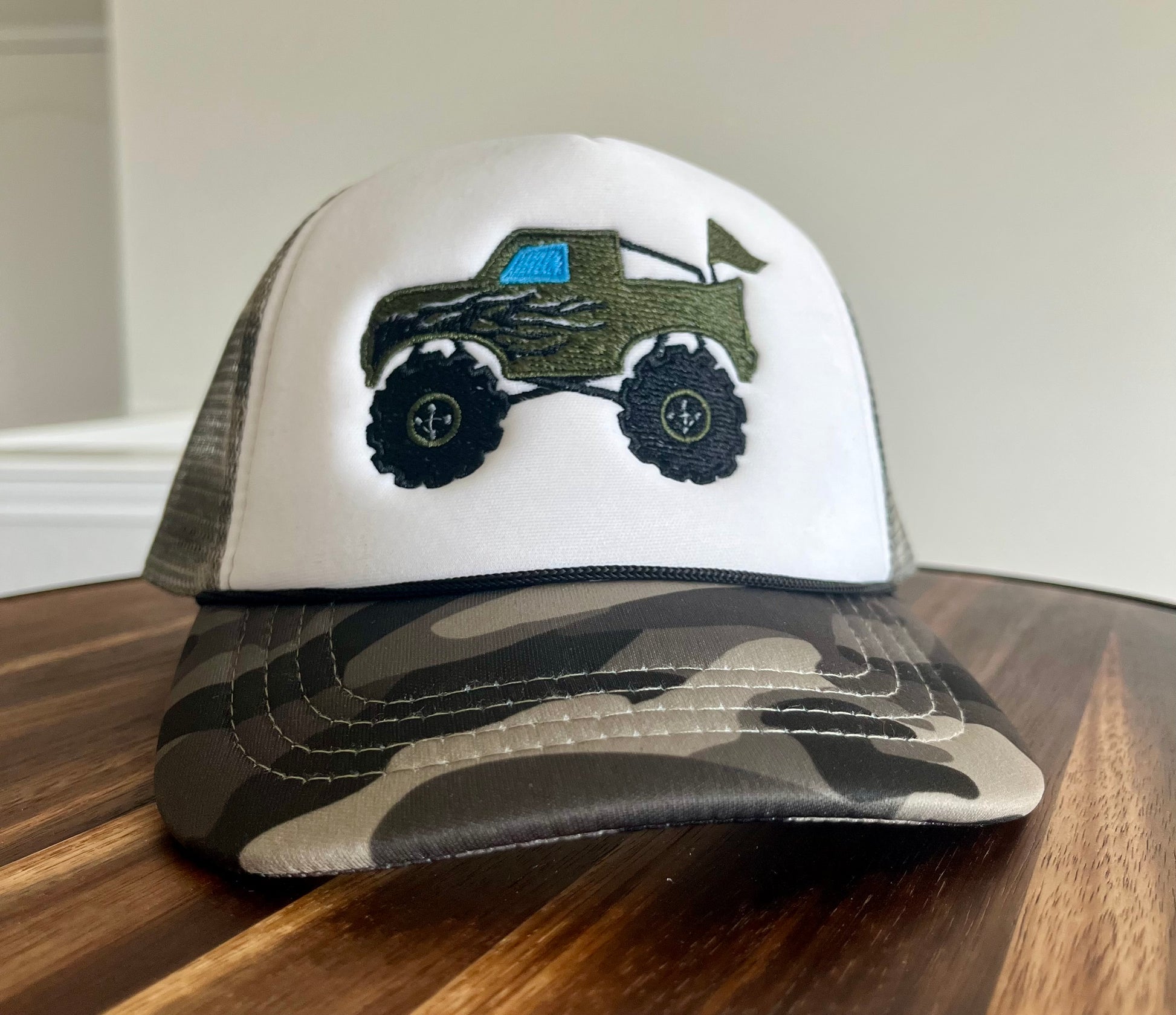 Trucker hat with a truck design on a wooden surface