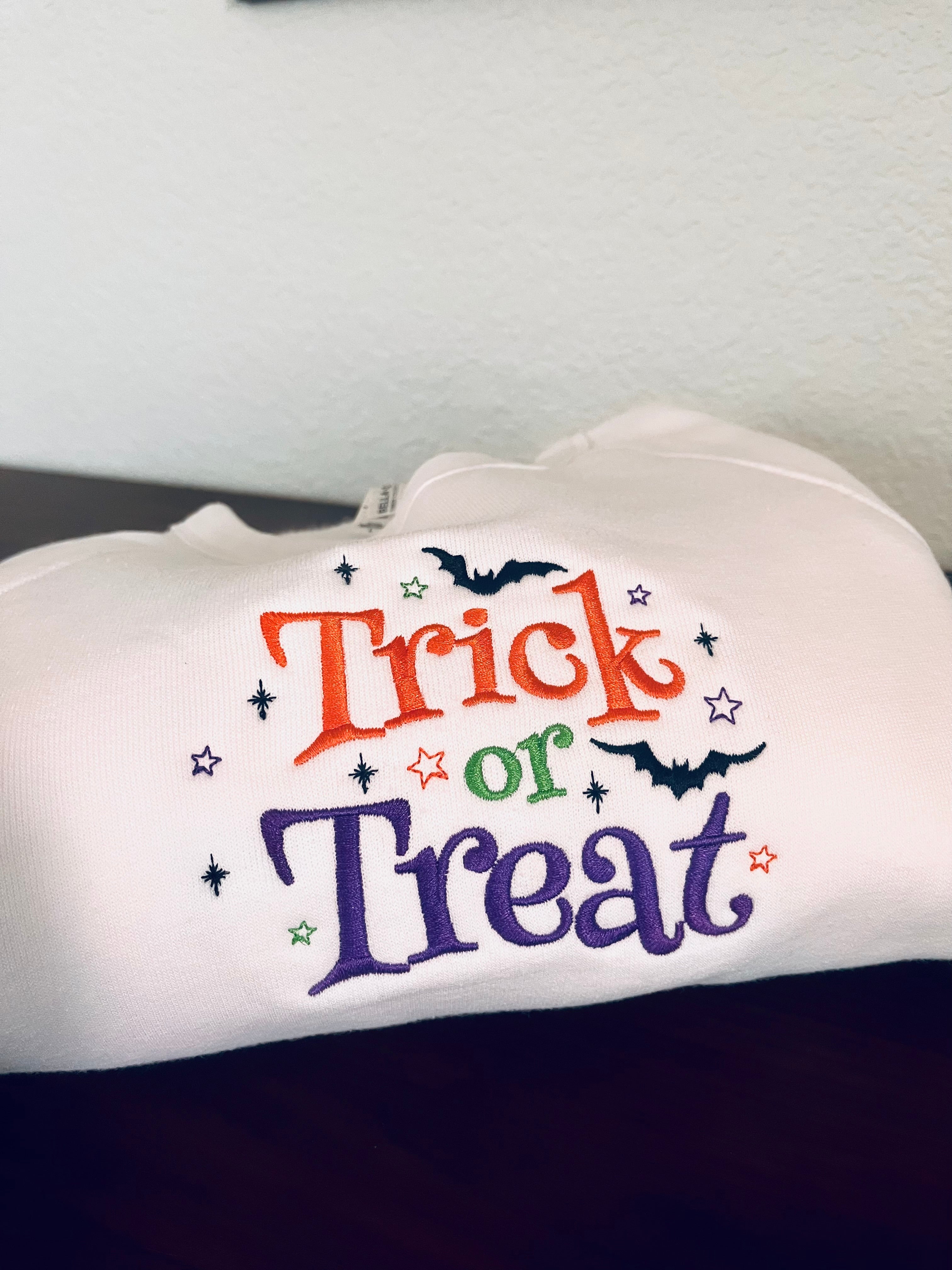 White shirt with 'Trick or Treat' text and Halloween graphics on a white background